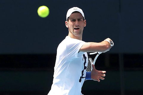 Defending champion Serbia's Novak Djokovic plays a forehand return during a practice session in the Rod Laver Arena ahead of the Australian Open at Melbourne Park. (Photo | AP)