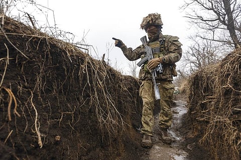 A Ukrainian soldier walks in a trench at the line of separation from pro-Russian rebels, Donetsk region, Ukraine, Monday, Jan. 10, 2022. (Photo | AP)