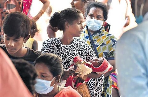 A woman waits for her allotment of housing unit by the TNUHDB at KP Park in Pulianthope, in Chennai on Tuesday | P Jawahar