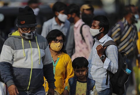 Passengers wearing face masks as a precaution against coronavirus arrive at a railway station in Hyderabad. (Photo | AP)