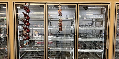 The milk shelf is mostly empty at a giant grocery store in Washington. (Photo | AP)