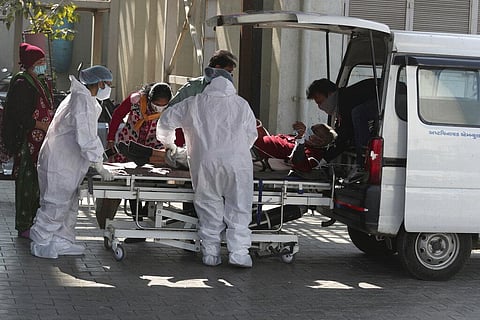 Health workers shift a patient on a stretcher at a COVID-19 hospital in Ahmedabad, India, Wednesday, Jan. 12, 2022. (Photo | AP)