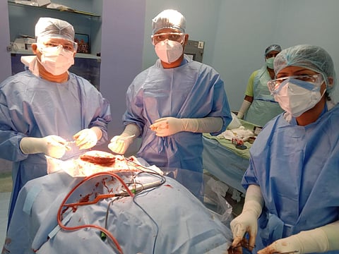 Neurosurgeon Dr Rama Chandra Deo (left) and his team conducting the surgery on the baby. (Photo | EPS)