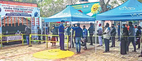 Patients with Covid-19 symptoms wait at the Covid Fever Clinic on Capital Hospital premises in Bhubaneswar on Wednesday, Jan 12, 2022. (Photo I Express)