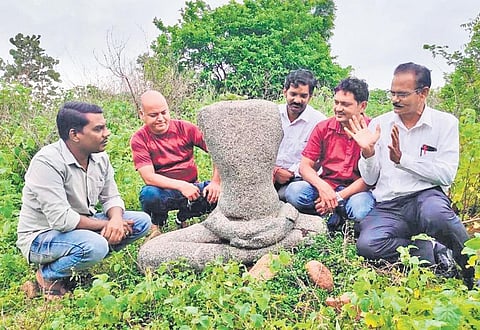 FILE - Members of the Kotha Telangana Charithra Brundam with a Mahavira sculpture