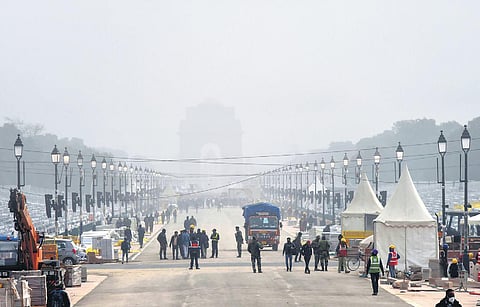 Fog covers the capital as preparations go on at Rajpath ahead of the Republic Day parade, on Wednesday. (Photo | PTI)