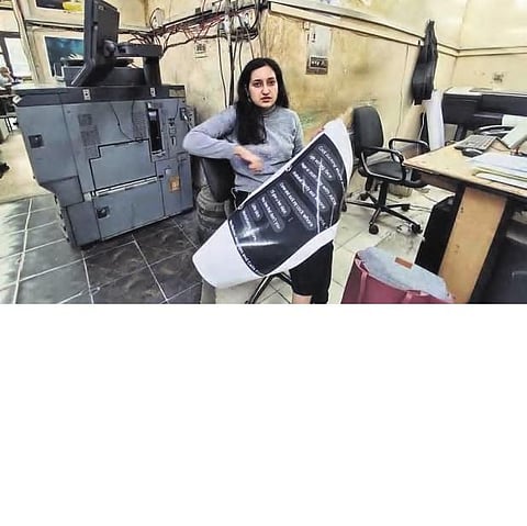 Isha Yadav getting the screenshots printed for the museum of rape threats and sexism