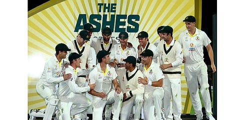 Australia's players pose with the trophy after winning the Ashes cricket match and the series against England in Hobart, Australia, Sunday, Jan. 16, 2022. (Photo | AP)