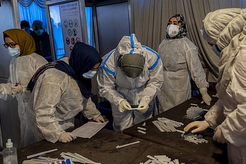 Health workers test nasal swab samples for COVID-19 in Srinagar, Indian controlled Kashmir, Saturday, Jan. 15, 2022. (Photo | AP)