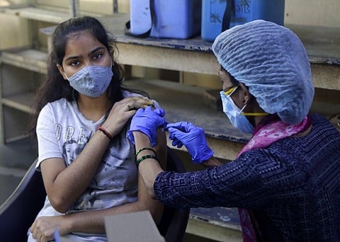A teenager receives her first dose of vaccine for COVID-19 at a college in Mumbai, India, Saturday, Jan. 15, 2022. (Photo | AP)
