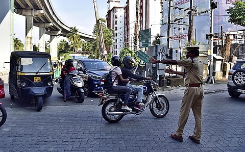 A police officer regulating traffic at Vyttila. Over 40 traffic officials in mufti will be deployed to monitor rule violations. (Photo| Albin Mathew, EPS)