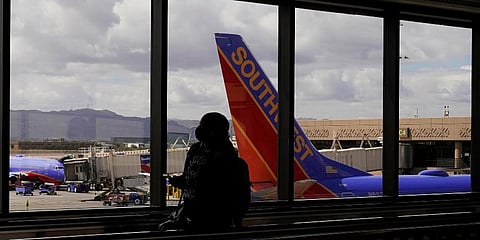 FILE - A passenger walks past a Southwest Airlines plane at Sky Harbor International Airport in Phoenix, March 26, 2021. (Photo | AP)
