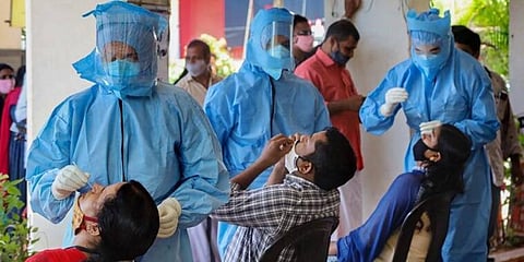 Health workers collect swab samples for COVID-19 tests in Kozhikode. (Photo | PTI)