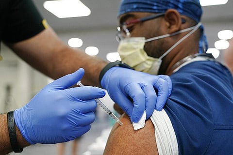 A healthcare worker receives a COVID-19 booster shot. (Photo | AP)