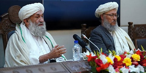 Taliban Prime Minister Mohammad Hasan Akhund, left, speaks during an economic conference at the former Presidential Palace in Kabul, Afghanistan, Wednesday, Jan. 19, 2022. (Photo | AP)