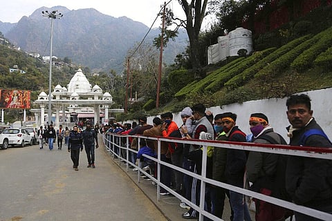 Hindu devotees line up to start their trek towards the holy cave of Mata Vaishnav Devi shrine following a fatal crowd surge, in Katra. (Photo | AP)