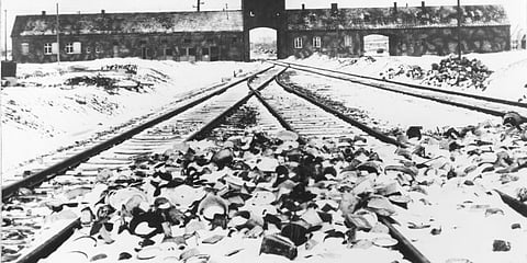 FILE- This February/March 1945, file photo shows the entry to the concentration camp Auschwitz-Birkenau in Poland, with snow covered rail tracks leading to the camp. (Photo | AP)