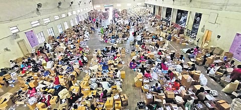 Workers pack Covid isolation kits at the Victory Playground Indoor Stadium in Hyderabad on Friday | R V K Rao