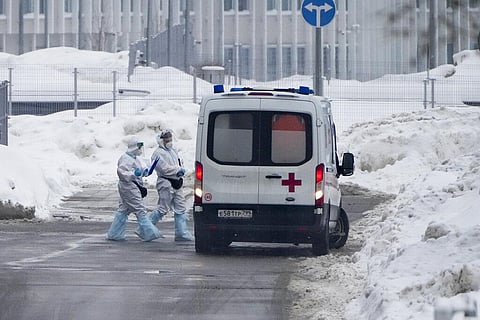Medical workers walk to an ambulance at a hospital in Kommunarka, outside Moscow, Russia, Sunday, Jan. 23, 2022. (Photo | AP)