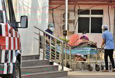 Hospital employees shift a patient to the COVID triage centre at Vijayawada government hospital. (File photo)