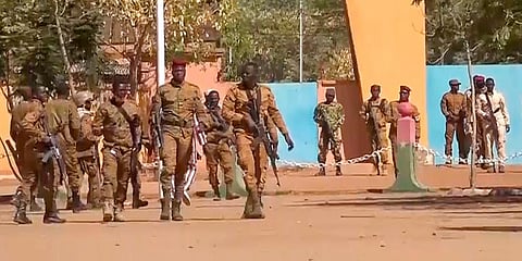 Burkina Faso mutinous soldiers walk outside the Guillaume Ouedraogo military camp in Ouagadougou. (Photo | AP)