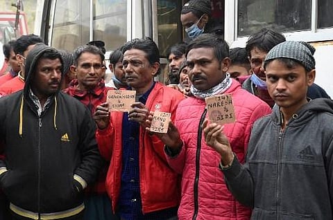 Indian fishermen arriving from Karachi stand in front of a vehicle in Lahore on January 24, 2022, after their released as they were imprisoned for fishing in Pakistan territorial waters. (Photo | AFP)
