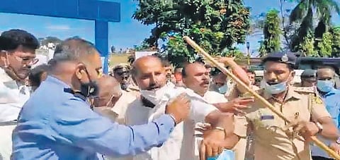 Police disperse people in front of the Sri Devaraj Urs Medical College in Kolar