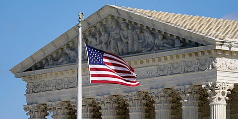 An American flag waves in front of the Supreme Court building on Capitol Hill in Washington. (Photo | AP)