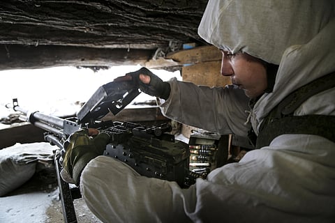A serviceman checks his machine-gun in a shelter on the territory controlled by pro-Russian militants at frontline with Ukrainian government forces in Slavyanoserbsk, Luhansk region, eastern Ukraine.
