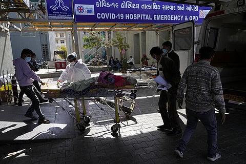 Health workers bring a COVID-19 patient to be admitted to Civil Hospital in Ahmedabad. (Photo | AP)