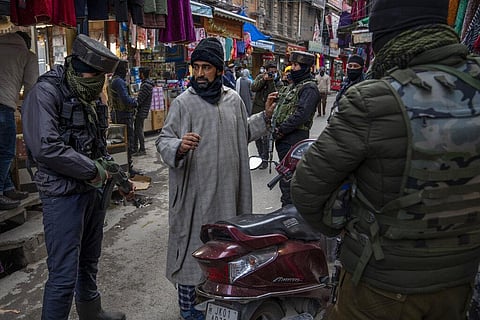 Jammu and Kashmir Special Operation Group (SOG) personnel interrogate a motorcyclist after a grenade attack by suspected rebels on the eve of Indian Republic Day. (Photo | AP)