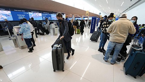 Travelers in the terminal of Denver International Airport on Friday, Dec. 24, 2021, in Denver. (Photo | AP)