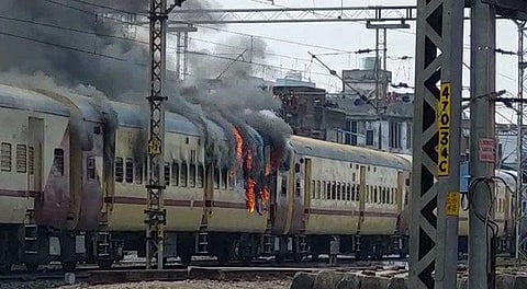A crowd stormed the Gaya Junction, raising slogans, and set fire to the train. (Photo | Special arrangement)