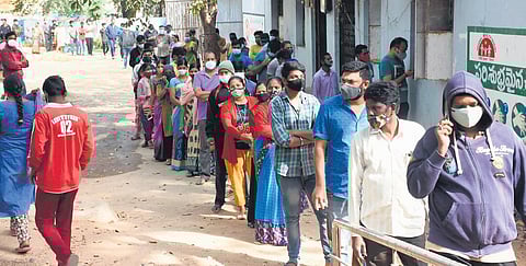 People stand in a long queue at Lingampalli Government Hospital to get tested for Covid-19, in Hyderabad, on Thursday