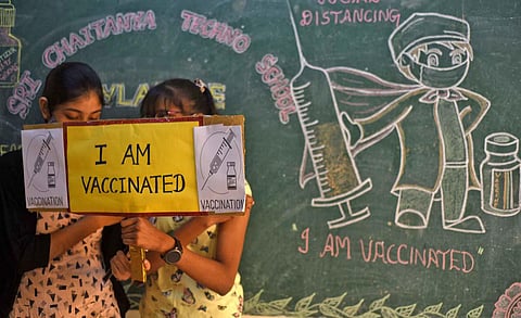 Children pose for a photo after getting vaccinated at school in Chennai. (Photo | R Satish Babu, EPS)