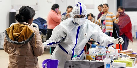 A healthcare worker interacts with a COVID-19 patient at the CWG village isolation center, in New Delhi. (File photo| ANI)