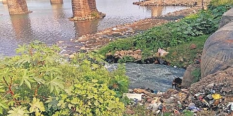 Waste being discharged into Mahanadi river from sluice gate at Jobra. (Photo | EPS)
