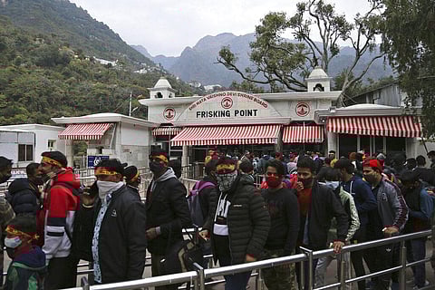Hindu devotees line up at the frisking point before trekking towards the holy cave of Mata Vaishnav Devi shrine following a fatal crowd surge in Katra. (Photo | AP)