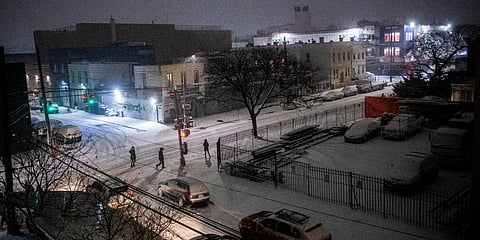 People cross the street during a snow storm in the Ridgewood section of Queens borough of New York. (Photo| AP)