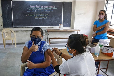 A health worker administers COVID-19 vaccine to a student at a school in Ahmedabad, India, Monday, Jan. 3, 2022. (Photo | AP)