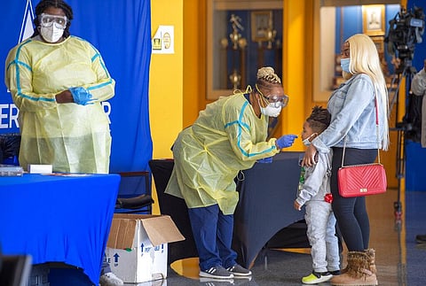 COVID-19 tests are administered to children, Monday, Jan. 3, 2022, at L.B. Landry High School in the Algiers neighborhood of New Orleans. (Photo | AP)