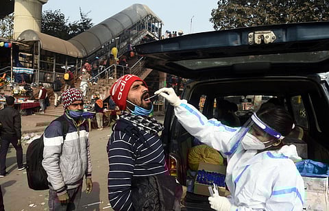 A health worker collect swab sample from a person in Delhi. (Photo | Parveen Negi, EPS)
