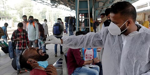 A medic collects swab sample (Photo | AP)