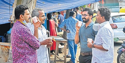People enjoying tea in disposible cups in front of a shop near the Secretariat on Tuesday | B P Deepu