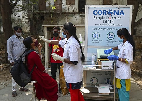 A health worker takes a nasal swab sample of a woman to test for COVID-19 in Hyderabad, India, Wednesday, Jan. 5, 2022. (Photo | AP)