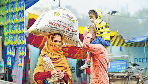 People walk on a street on a cold and foggy morning, in New Delhi. (Photo| PTI)