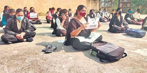 B.Ed students staging protest over conduct of offline examination at the District Institute for Education and Training in Jagatsinghpur on Thursday. (Photo | EPS)