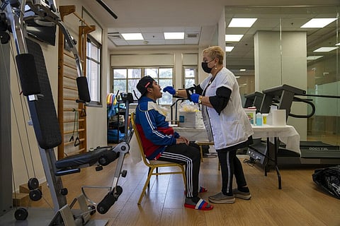 A man gets a PCR coronavirus test at a private nursing home in Netanya, Israel, Wednesday, Jan. 5, 2022. (Photo | AP)