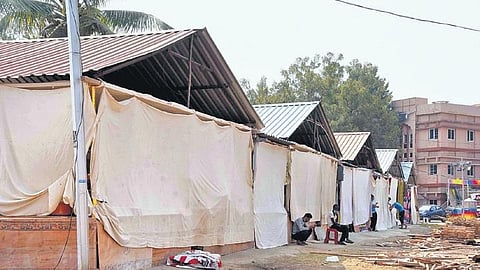 Shop owners sit outside their stalls after the State government temporarily suspended Numaish in Hyderabad. (File photo | EPS, RVK Rao)