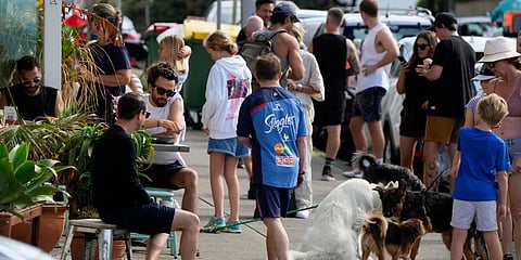 Customers wait outside a cafe at Bondi Beach in Sydney, Australia, Saturday, Jan. 8, 2022. (Photo | AP)